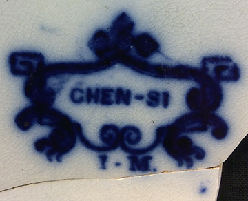 Printed flow blue underglaze refined white earthenware plate with a Chinoiserie landscape motif pattern named “Chen-Si”. Printed manufacturer’s mark on reverse for John Meir, Staffordshire (1812-1836). Rim diameter: 7.75”, from 18BC27, Feature 30.